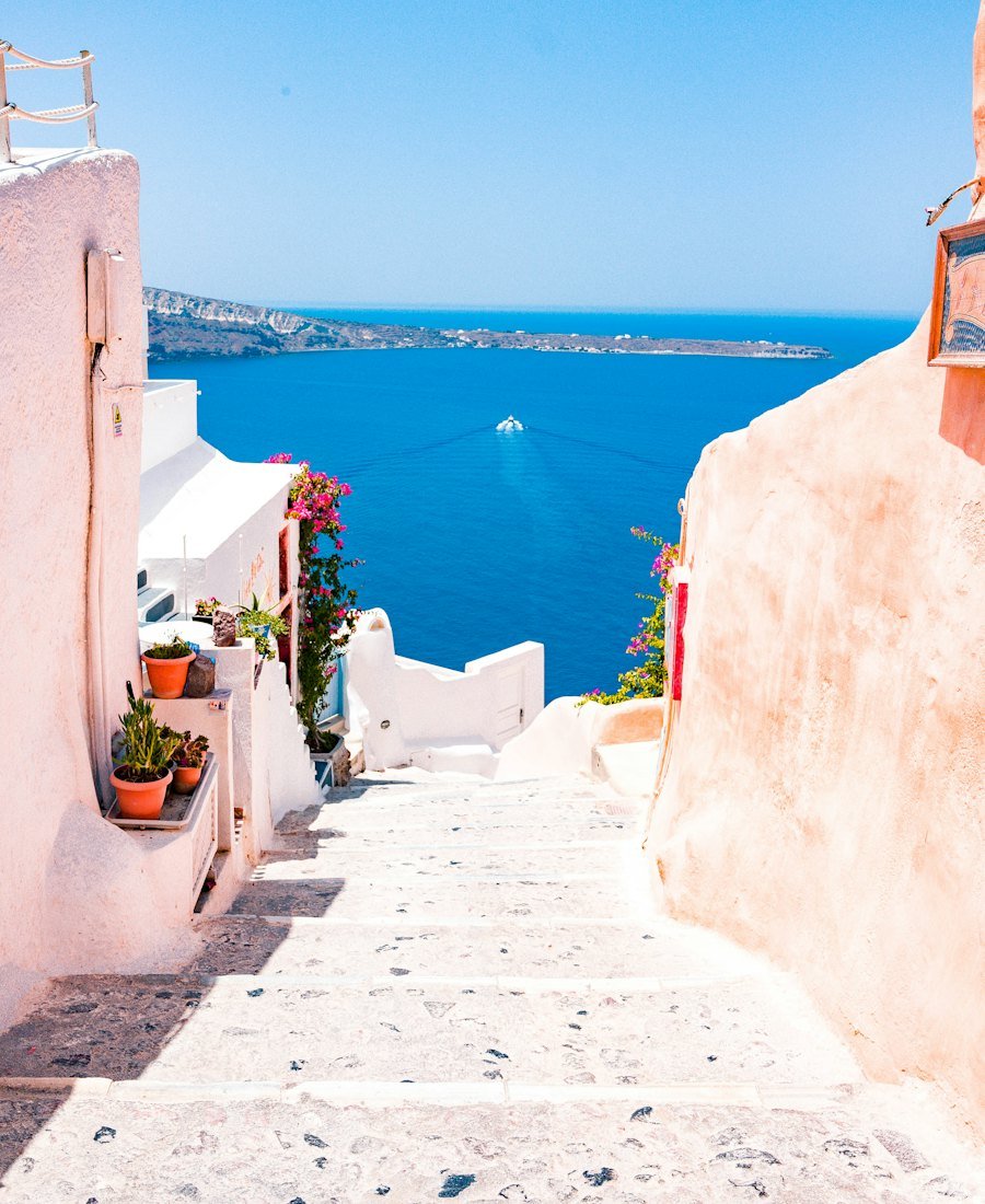 Whitewashed steps and a blue dome above the Aegean in Santorini