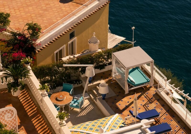 A clifftop terrace with lounge chairs overlooking the sea on the Amalfi Coast