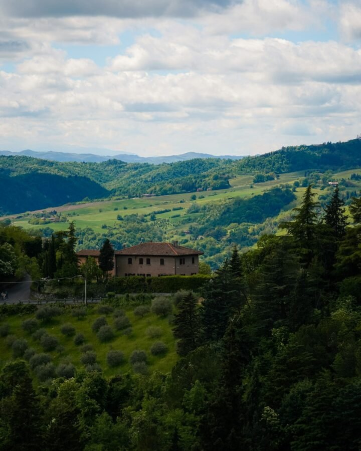A country house on a hill above rolling Tuscan countryside