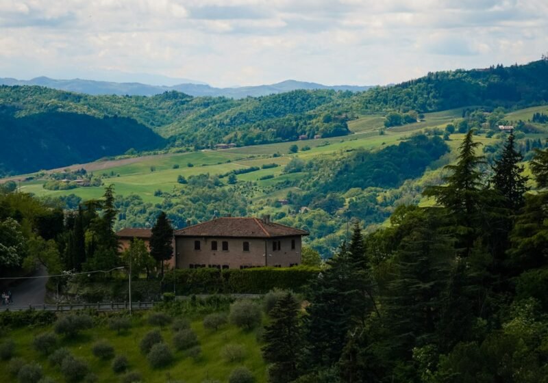 A country house on a hill above rolling Tuscan countryside